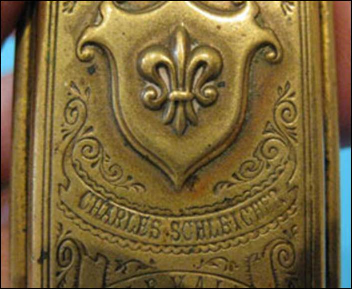 A close-up of a gold plaque

Description automatically generated