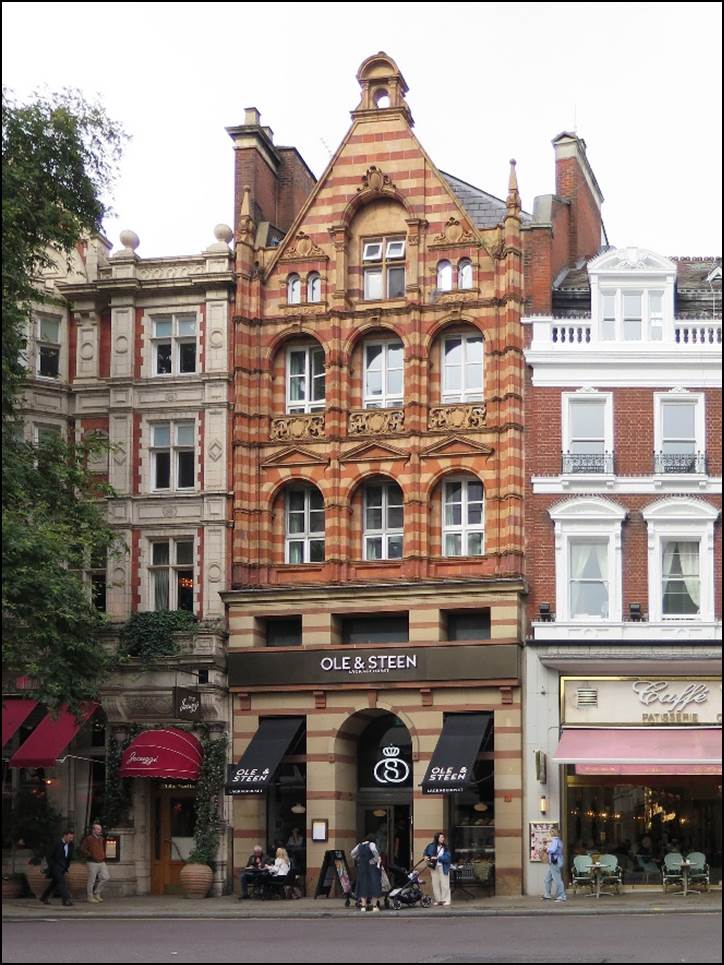 A group of people walking in front of a building

Description automatically generated