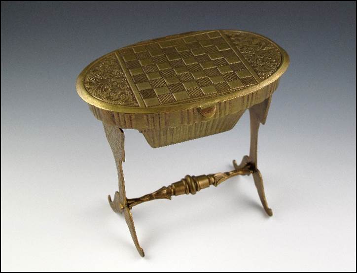 A small gold table with a carved surface

Description automatically generated with medium confidence